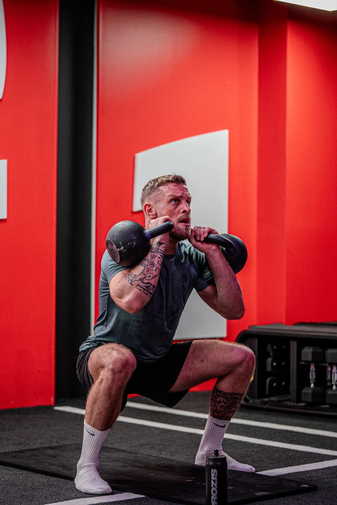 Jordan Faelens, fondateur de FADER, en squat kettlebell